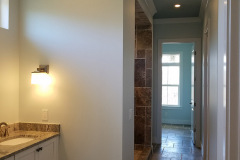 Master bathroom with ceiling lights and sconce