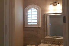 Round tray ceiling in bathroom with ceiling and vanity fixtures