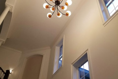 Two-story foyer with custom light fixture and medallion