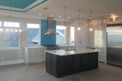 Custom kitchen in Flagler Beach with pendant lights, ceiling LED lighting and interior cabinet lighting-in-top-cabinets
