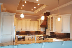 LED lights in tray ceiling and pendant lights over bar